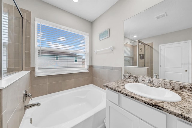32136 Conchshell Sail St, Wesley Chapel, FL 33545 - full bathroom featuring a bath, vanity, and a stall shower
