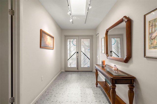 5782 Westshore Dr, New Port Richey, FL 34652 - entryway featuring rail lighting, tile patterned floors, french doors, and baseboards