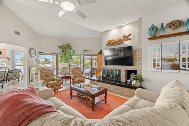 5782 Westshore Dr, New Port Richey, FL 34652 - living room with vaulted ceiling, a ceiling fan, a glass covered fireplace, and a textured ceiling