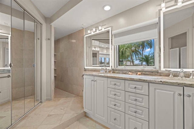 5782 Westshore Dr, New Port Richey, FL 34652 - bathroom featuring double vanity and tiled shower