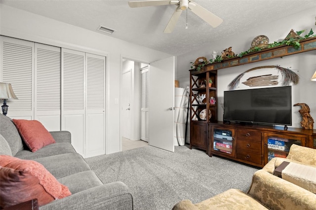 5782 Westshore Dr, New Port Richey, FL 34652 - carpeted living area with ceiling fan and a textured ceiling