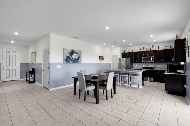 12481 Aston Dr, Hudson, FL 34669 - dining area with light tile patterned floors, recessed lighting, and baseboards
