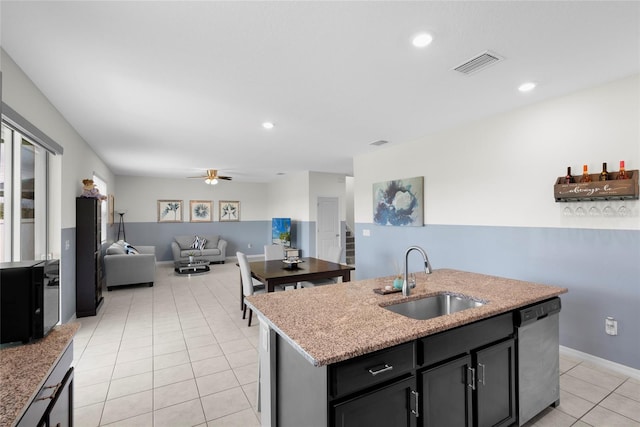 12481 Aston Dr, Hudson, FL 34669 - kitchen with a sink, dishwasher, light tile patterned floors, open floor plan, and a center island with sink