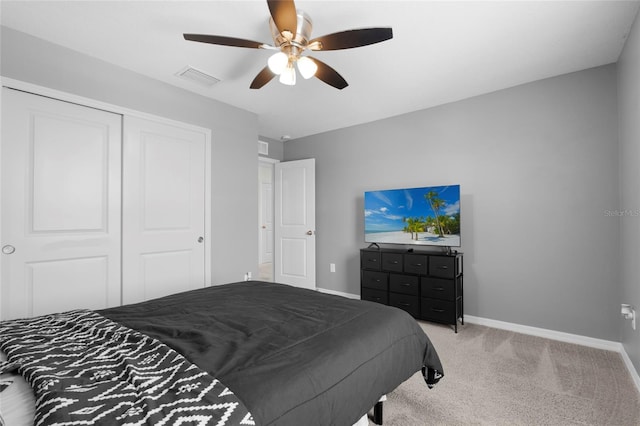 12481 Aston Dr, Hudson, FL 34669 - bedroom with baseboards, light carpet, a closet, and a ceiling fan