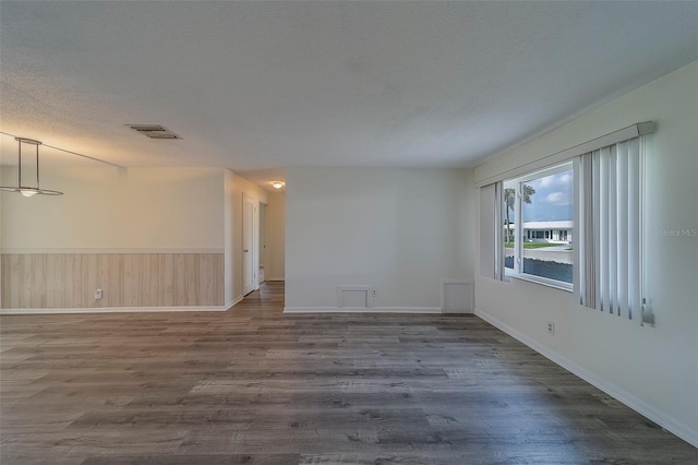 10005 41st St N, Pinellas Park, FL 33782 - spare room featuring dark wood-style floors, baseboards, and a textured ceiling