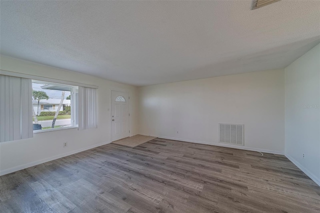 10005 41st St N, Pinellas Park, FL 33782 - unfurnished room with wood finished floors, a textured ceiling, and baseboards