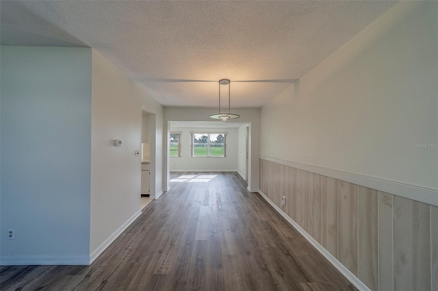 10005 41st St N, Pinellas Park, FL 33782 - hallway featuring dark wood-type flooring, a textured ceiling, and baseboards
