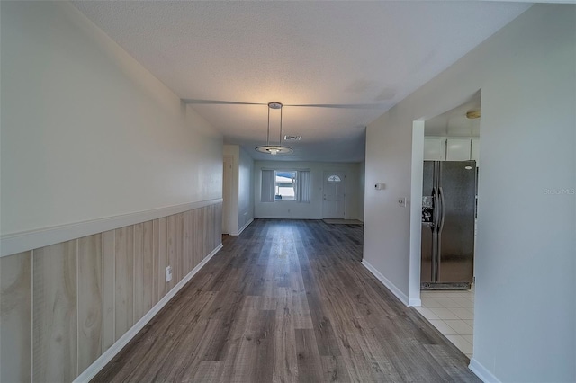 10005 41st St N, Pinellas Park, FL 33782 - corridor with wood finished floors, a wainscoted wall, wood walls, and baseboards
