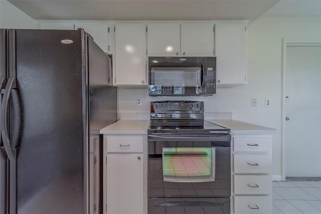 10005 41st St N, Pinellas Park, FL 33782 - kitchen featuring black appliances, light countertops, light tile patterned floors, and white cabinetry
