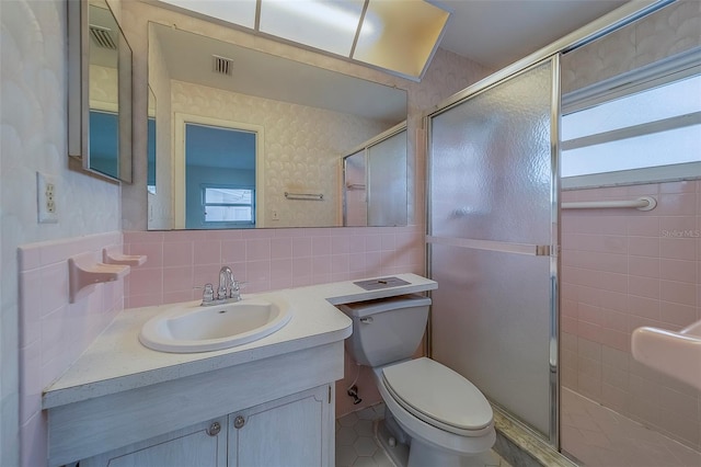 10005 41st St N, Pinellas Park, FL 33782 - full bathroom featuring tasteful backsplash, vanity, a shower stall, toilet, and tile walls