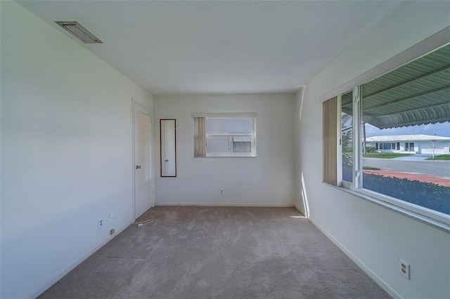 10005 41st St N, Pinellas Park, FL 33782 - carpeted spare room featuring baseboards