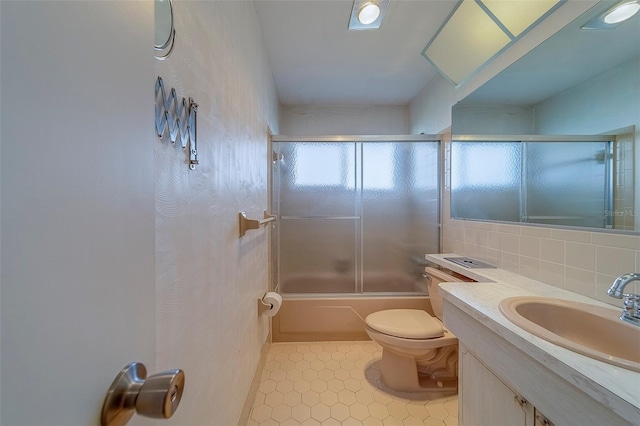 10005 41st St N, Pinellas Park, FL 33782 - full bath featuring toilet, tile patterned floors, vanity, combined bath / shower with glass door, and tasteful backsplash
