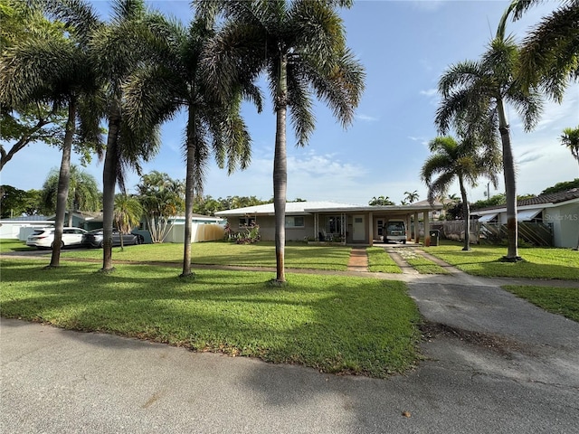 2160 NE 53rd St, Fort Lauderdale, FL 33308 - ranch-style home featuring concrete driveway, a front lawn, a carport, and a porch