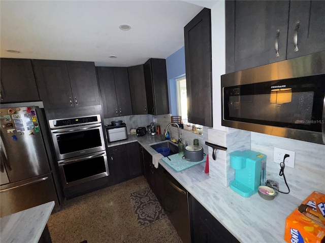 2160 NE 53rd St, Fort Lauderdale, FL 33308 - kitchen with stainless steel appliances, dark cabinets, a sink, and decorative backsplash