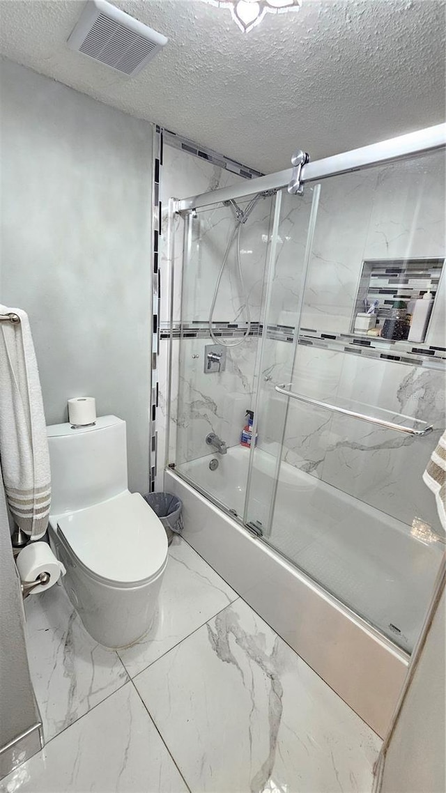 6424 Thicket Trl, New Port Richey, FL 34653 - bathroom featuring bath / shower combo with glass door, toilet, a textured ceiling, and marble finish flooring
