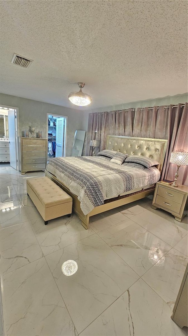 6424 Thicket Trl, New Port Richey, FL 34653 - bedroom featuring light marble finish flooring and a textured ceiling