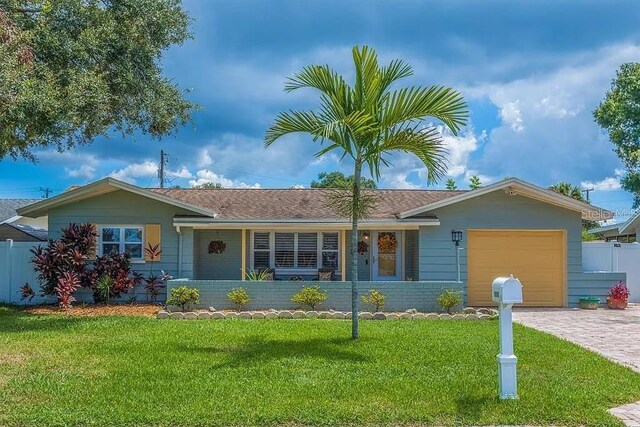10339 111th St, Largo, FL 33778 - ranch-style house featuring an attached garage, driveway, and a shingled roof
