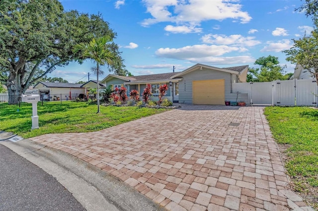 10339 111th St, Largo, FL 33778 - single story home featuring a gate, decorative driveway, and a garage