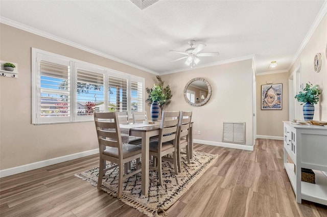 10339 111th St, Largo, FL 33778 - dining room with light wood-type flooring, ornamental molding, and ceiling fan