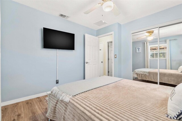 10339 111th St, Largo, FL 33778 - bedroom with wood finished floors, a closet, and ceiling fan