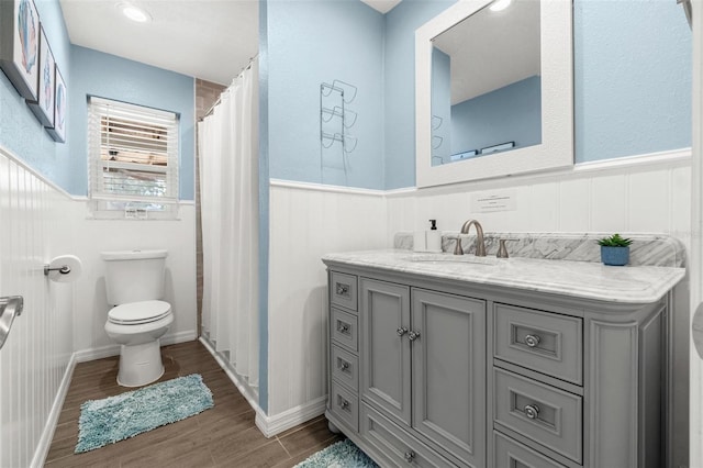 10339 111th St, Largo, FL 33778 - bathroom featuring a wainscoted wall, wood finished floors, vanity, and a shower with curtain
