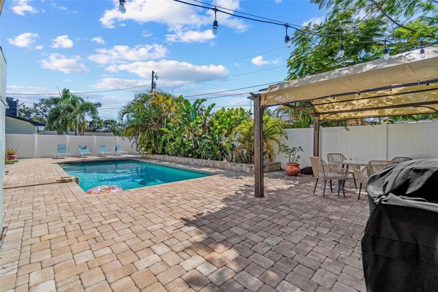 10339 111th St, Largo, FL 33778 - view of pool featuring a patio, a fenced backyard, and outdoor dining space