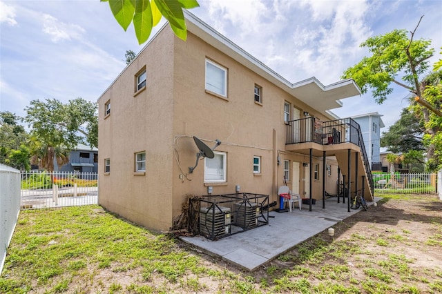 1771 Russell St S, Saint Petersburg, FL 33712 - back of house with stucco siding, a balcony, and a patio area