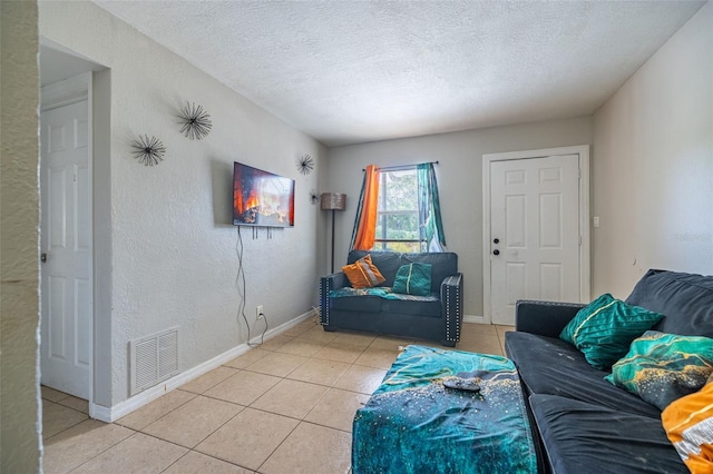 1771 Russell St S, Saint Petersburg, FL 33712 - living room featuring light tile patterned floors, a textured ceiling, and a textured wall