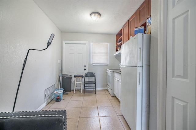 1771 Russell St S, Saint Petersburg, FL 33712 - kitchen featuring white appliances, light tile patterned floors, open shelves, brown cabinets, and a textured ceiling