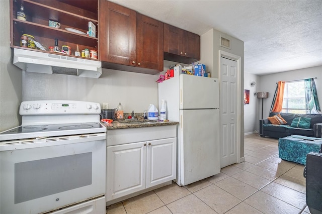 1771 Russell St S, Saint Petersburg, FL 33712 - kitchen with white appliances, under cabinet range hood, light tile patterned floors, a textured ceiling, and open floor plan