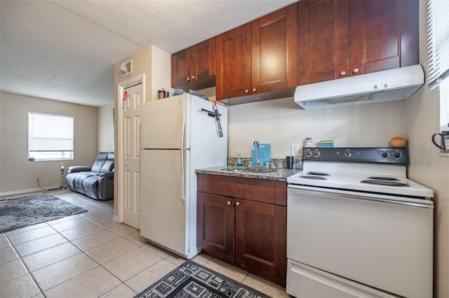 1771 Russell St S, Saint Petersburg, FL 33712 - kitchen with white appliances, under cabinet range hood, open floor plan, light tile patterned flooring, and light stone counters