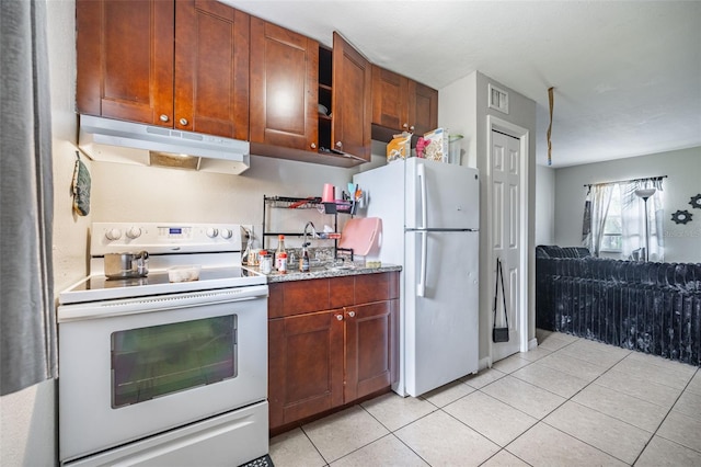 1771 Russell St S, Saint Petersburg, FL 33712 - kitchen featuring white appliances, under cabinet range hood, light tile patterned floors, brown cabinets, and light stone countertops