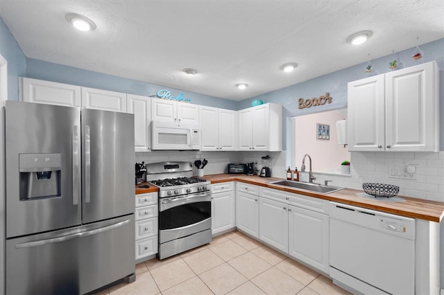 3905 31st Ave W, Bradenton, FL 34205 - kitchen with stainless steel appliances, butcher block counters, backsplash, and white cabinetry