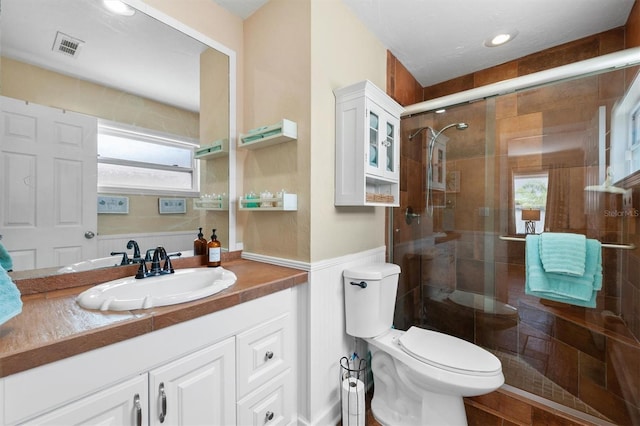 3905 31st Ave W, Bradenton, FL 34205 - full bath featuring vanity, a stall shower, a wainscoted wall, and recessed lighting
