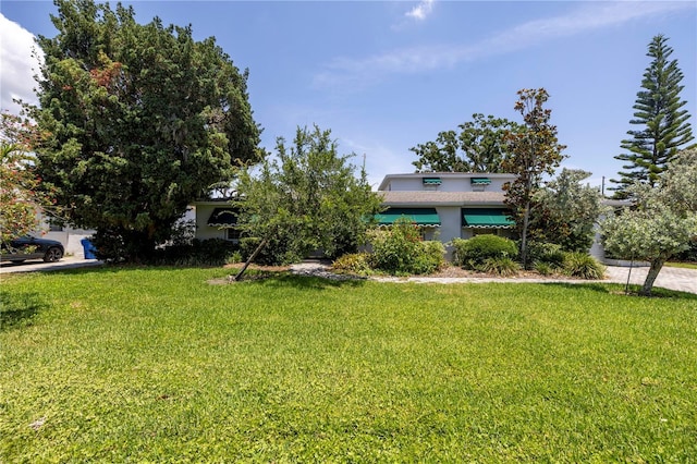 167 Almedo Way NE, Saint Petersburg, FL 33704 - view of front of house with a front yard and stucco siding