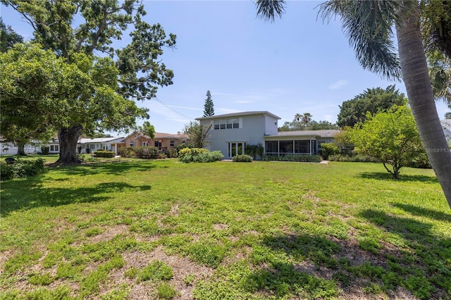 167 Almedo Way NE, Saint Petersburg, FL 33704 - view of green lawn with a sunroom