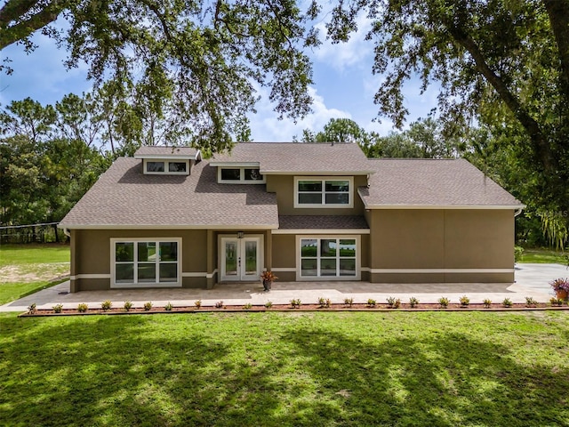 4044 Red Fox Ct, Wesley Chapel, FL 33543 - back of house featuring french doors, a yard, a shingled roof, stucco siding, and a patio