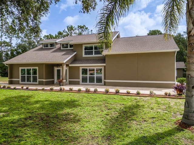 4044 Red Fox Ct, Wesley Chapel, FL 33543 - view of front facade with stucco siding, roof with shingles, and a front yard