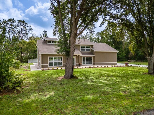 4044 Red Fox Ct, Wesley Chapel, FL 33543 - view of front of home featuring a front lawn, a patio, and stucco siding