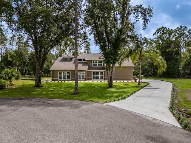 4044 Red Fox Ct, Wesley Chapel, FL 33543 - view of front of home featuring a front yard, concrete driveway, and stucco siding