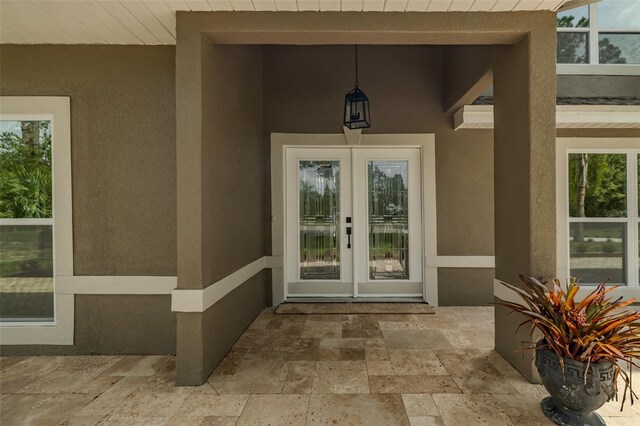 4044 Red Fox Ct, Wesley Chapel, FL 33543 - property entrance with stucco siding, french doors, and a patio