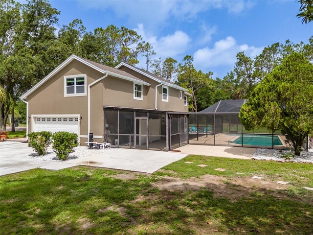 4044 Red Fox Ct, Wesley Chapel, FL 33543 - back of property featuring stucco siding, an outdoor pool, a patio, glass enclosure, and a garage