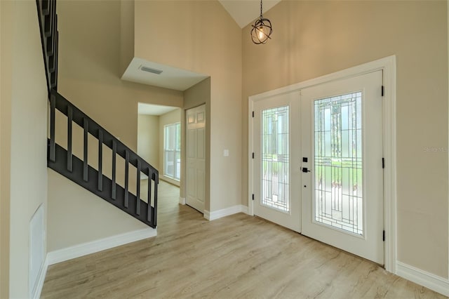 4044 Red Fox Ct, Wesley Chapel, FL 33543 - foyer entrance with stairs, high vaulted ceiling, wood finished floors, baseboards, and french doors