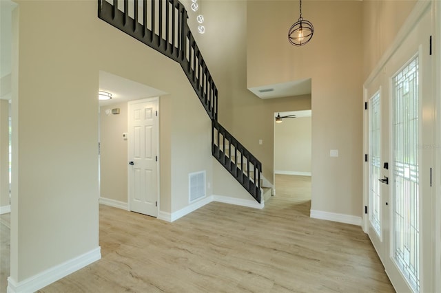 4044 Red Fox Ct, Wesley Chapel, FL 33543 - foyer with stairs, wood finished floors, a high ceiling, and baseboards