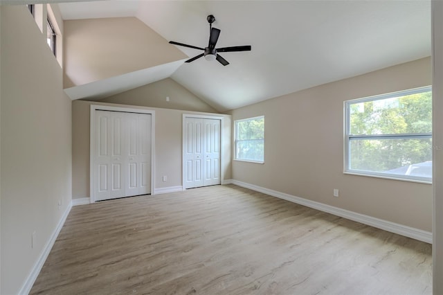 4044 Red Fox Ct, Wesley Chapel, FL 33543 - unfurnished bedroom featuring two closets, wood finished floors, lofted ceiling, baseboards, and ceiling fan
