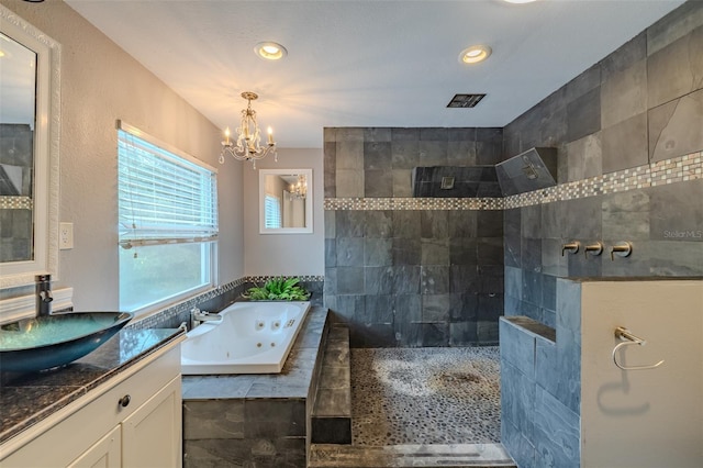 4044 Red Fox Ct, Wesley Chapel, FL 33543 - full bath featuring a whirlpool tub, vanity, a chandelier, walk in shower, and recessed lighting