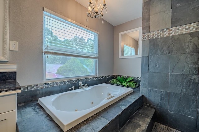 4044 Red Fox Ct, Wesley Chapel, FL 33543 - bathroom featuring a tub with jets, a chandelier, and vanity