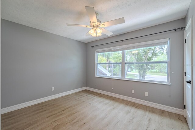 4044 Red Fox Ct, Wesley Chapel, FL 33543 - empty room with light wood-type flooring, baseboards, and a ceiling fan