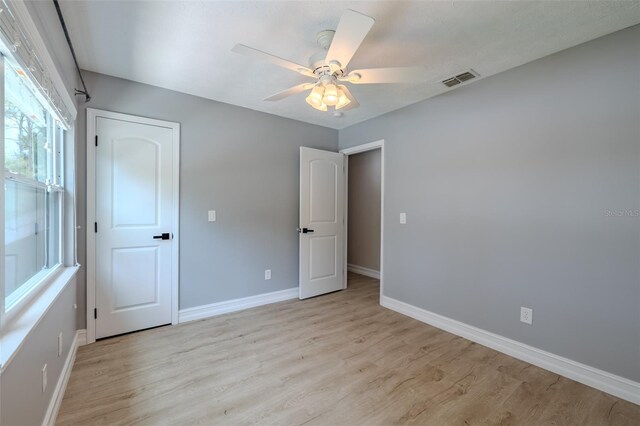 4044 Red Fox Ct, Wesley Chapel, FL 33543 - unfurnished bedroom featuring light wood-style floors, baseboards, and ceiling fan