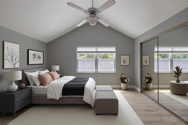 4044 Red Fox Ct, Wesley Chapel, FL 33543 - bedroom featuring light wood-style flooring, multiple windows, lofted ceiling, ceiling fan, and a closet